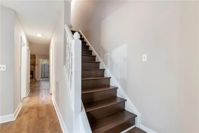 a view of entryway and gallery with wooden floor