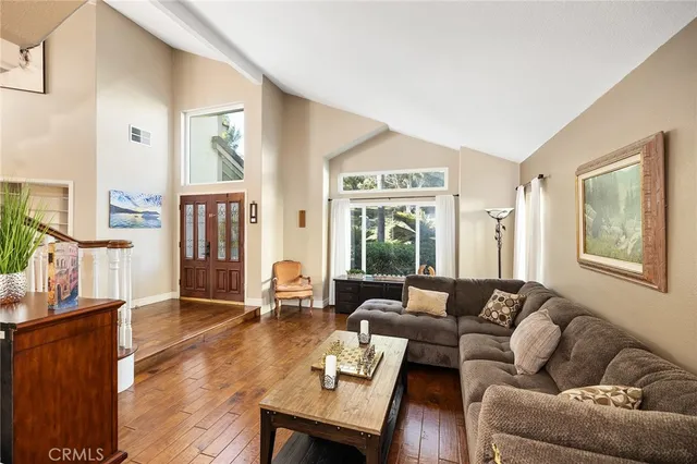 a view of a dining room with furniture a chandelier and wooden floor