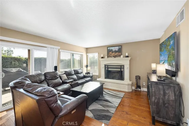 a kitchen with a stove top oven a sink dishwasher and a refrigerator with wooden cabinets
