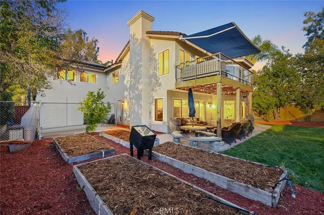 a front view of a house with a garden and garage