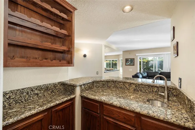 a bathroom with a granite countertop tub a sink and a large mirror