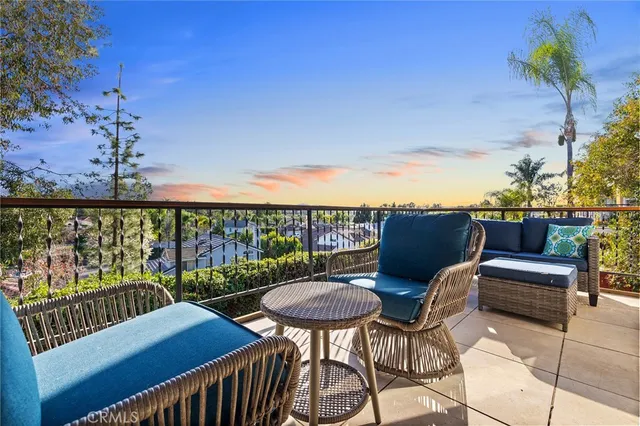 a living room with patio furniture and a potted plants
