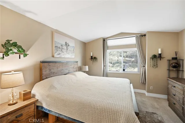 a view of a swimming pool with a lawn chairs under an umbrella