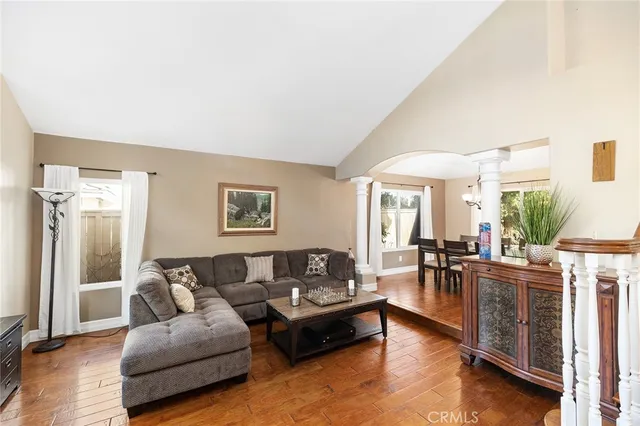 a living room with furniture and wooden floor