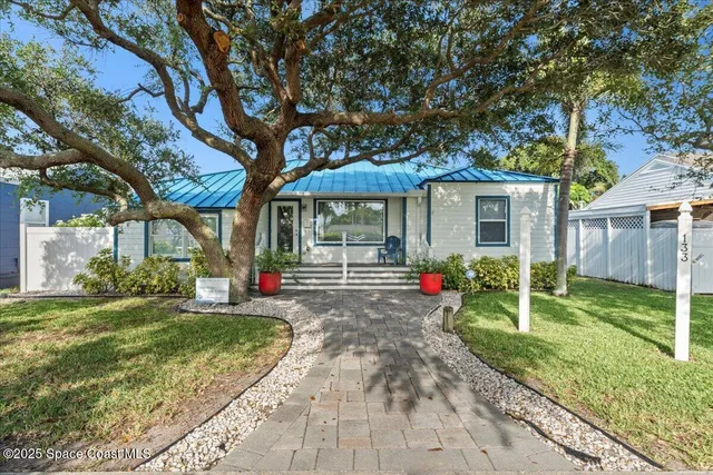 an aerial view of a residential houses with outdoor space