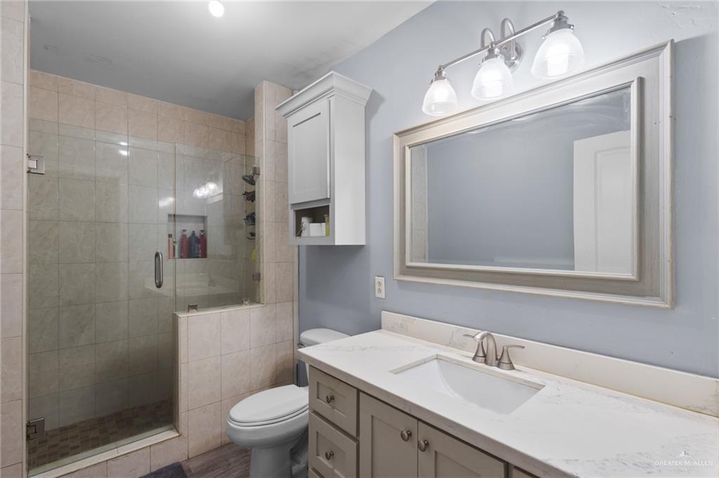 157 San Agustin Street Rio Grande City, TX 78582 - Photo 11 of 17 a bathroom with a sink a toilet and a mirror