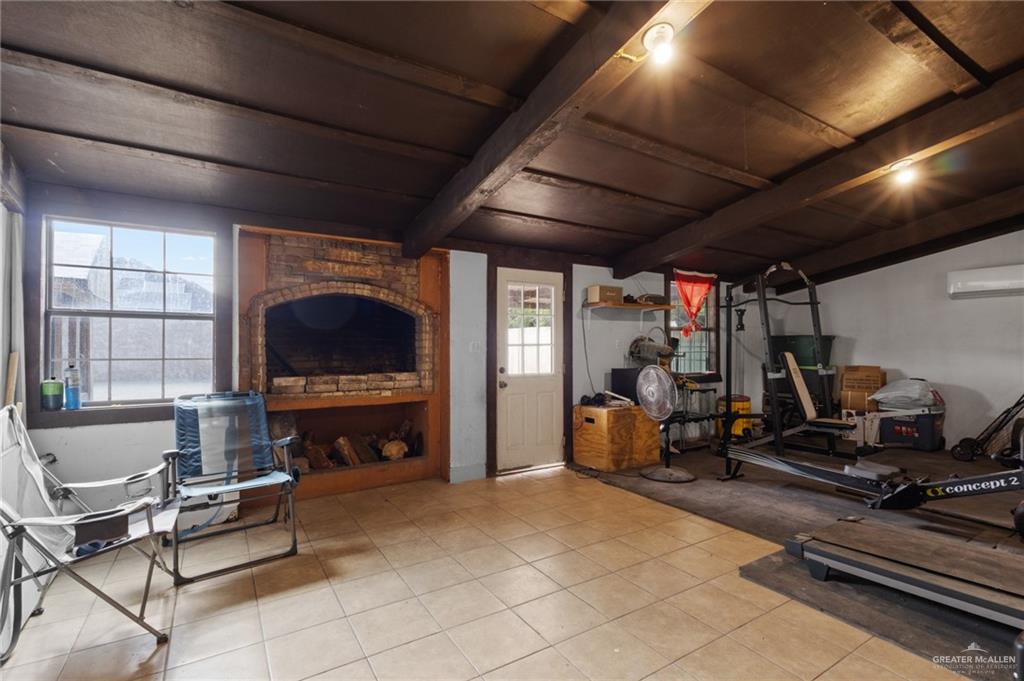 157 San Agustin Street Rio Grande City, TX 78582 - Photo 14 of 17 a living room with furniture gym equipment and a fireplace