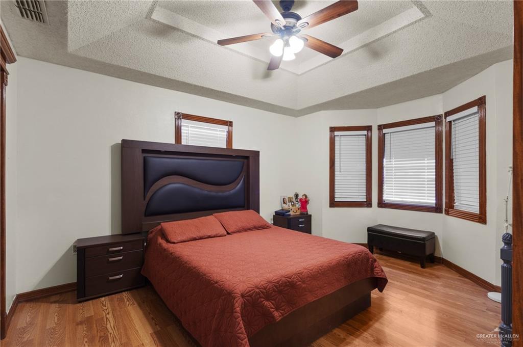 157 San Agustin Street Rio Grande City, TX 78582 - Photo 6 of 17 a bedroom with a bed and a ceiling fan