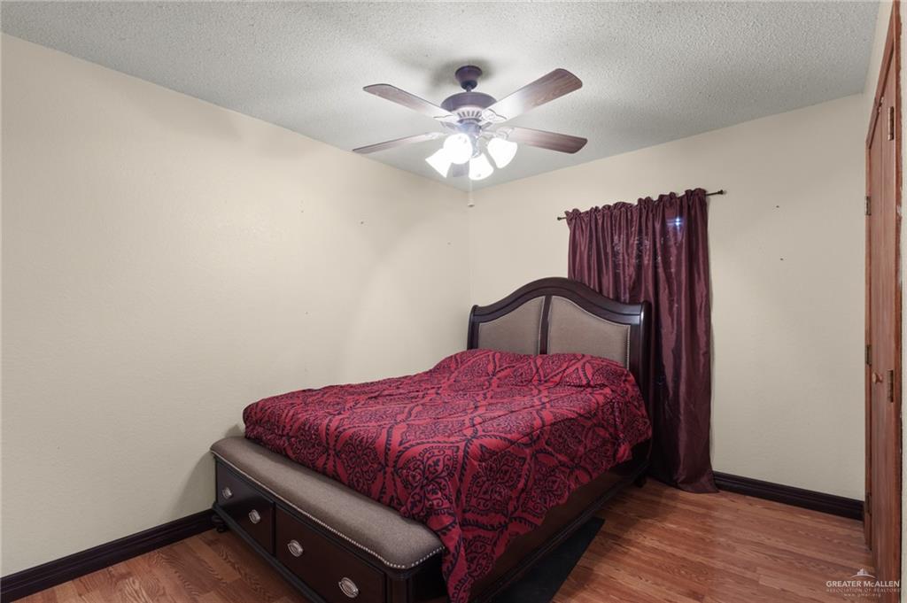157 San Agustin Street Rio Grande City, TX 78582 - Photo 8 of 17 a bedroom with a bed and a ceiling fan