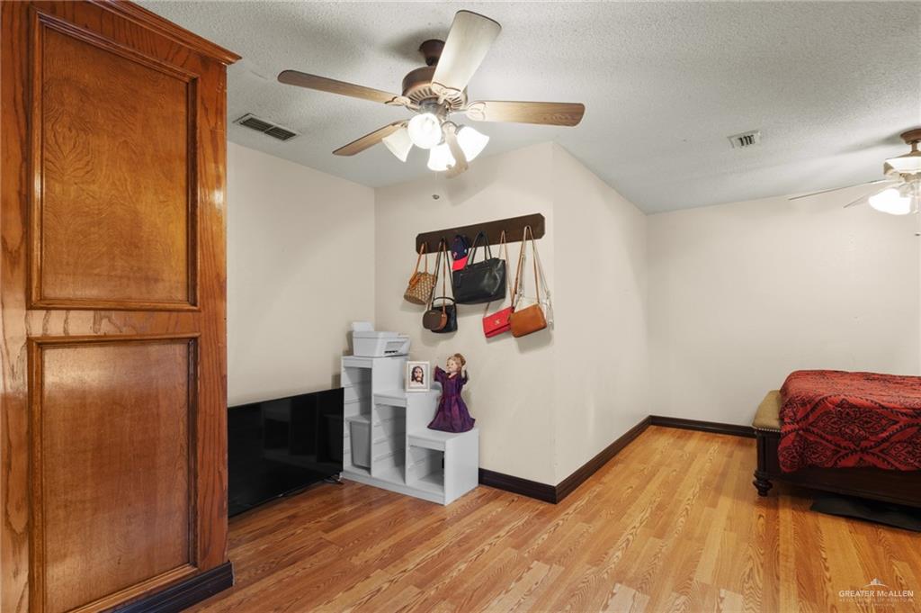 157 San Agustin Street Rio Grande City, TX 78582 - Photo 9 of 17 a view of a livingroom with wooden floor and a ceiling fan