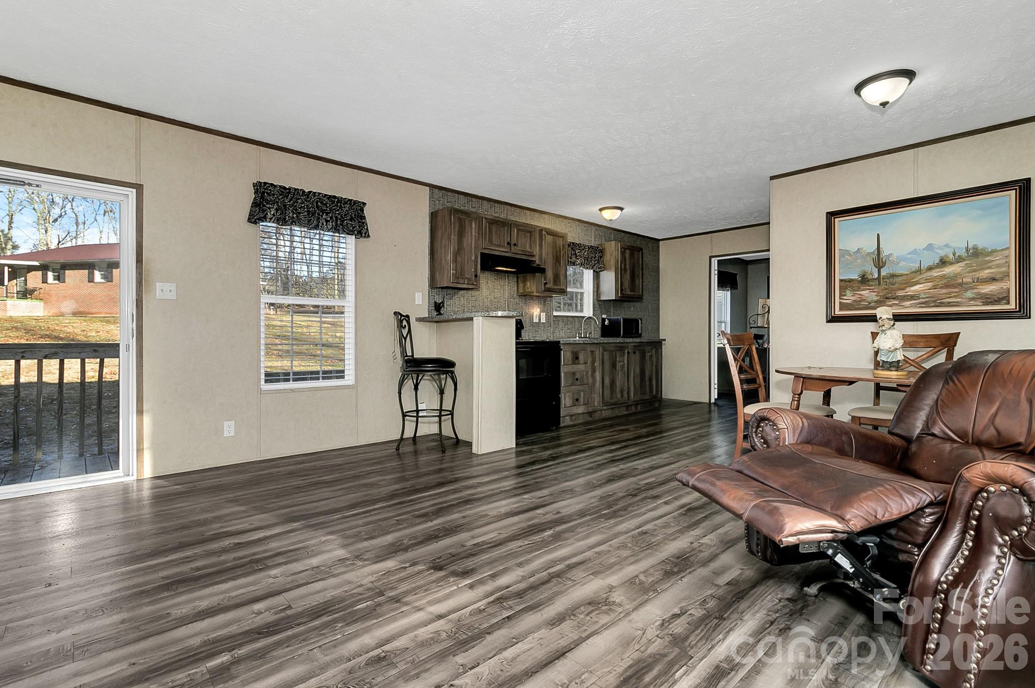 44 Tuttle Road Hendersonville, NC 28792 - Photo 33 of 37 a living room with furniture dining table wooden floor and a large window