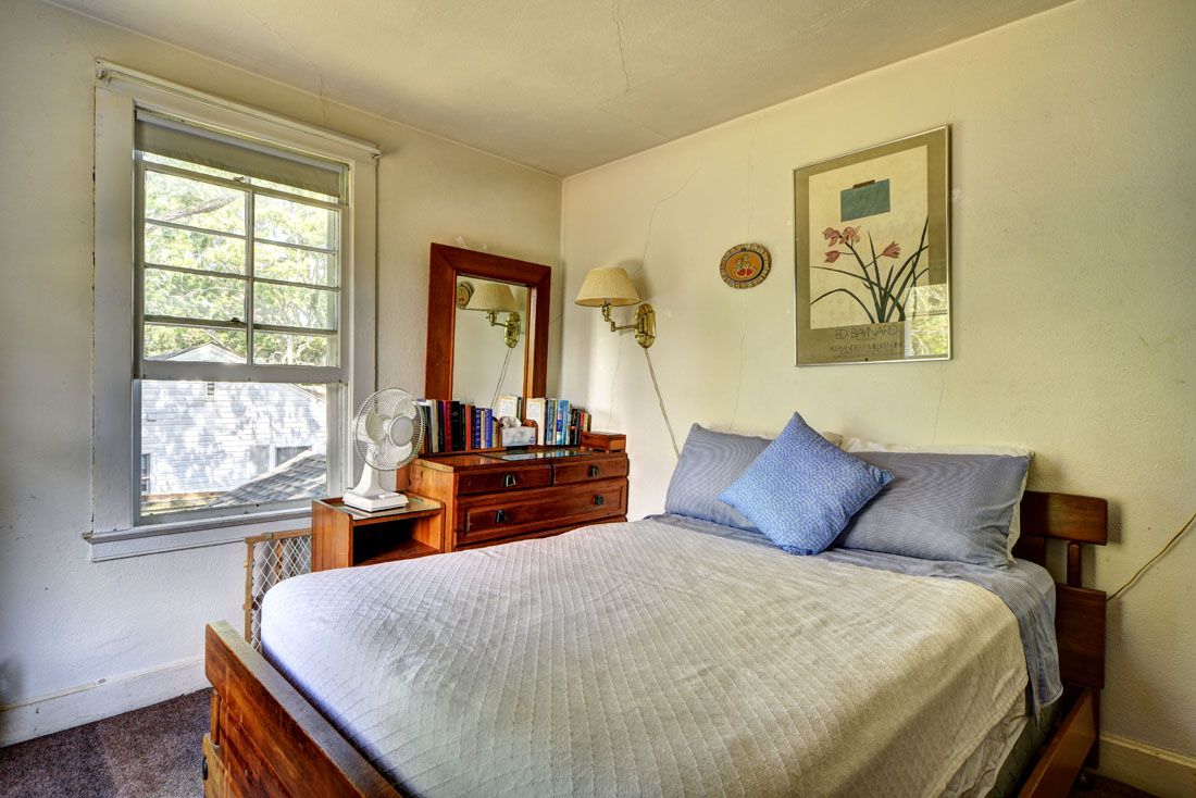 9 Bluff Point Lane Sag Harbor, NY 11963 - Photo 18 of 25 a bedroom with a bed and dresser with mirror