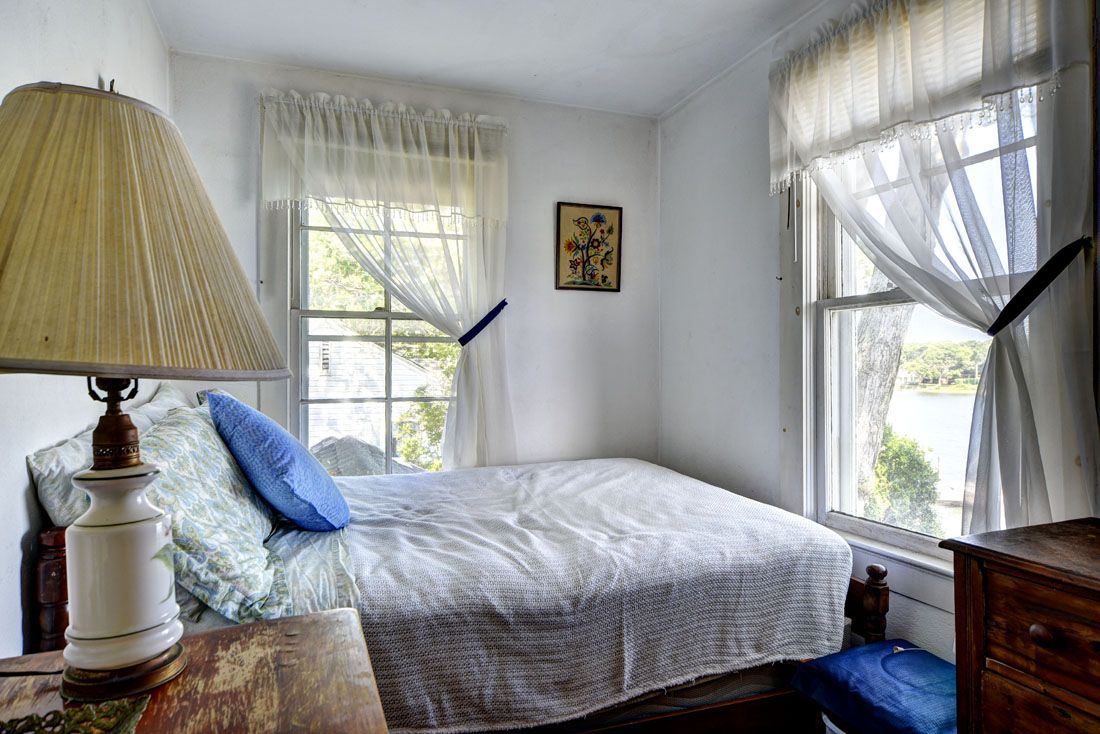 9 Bluff Point Lane Sag Harbor, NY 11963 - Photo 20 of 25 a bedroom with a bed and a window