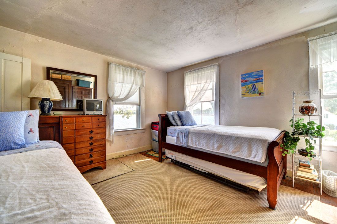 9 Bluff Point Lane Sag Harbor, NY 11963 - Photo 21 of 25 a bedroom with a bed and window