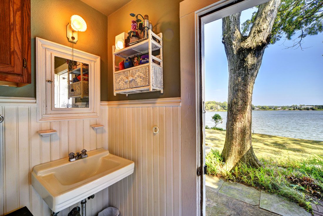9 Bluff Point Lane Sag Harbor, NY 11963 - Photo 22 of 25 a bathroom with a sink and a mirror