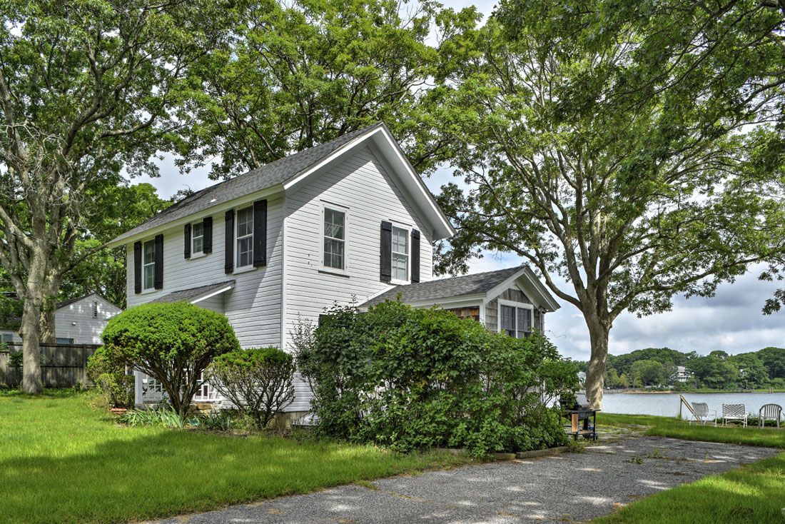 9 Bluff Point Lane Sag Harbor, NY 11963 - Photo 5 of 25 a front view of a house with a garden