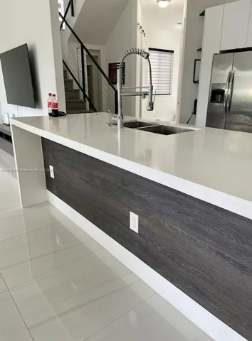 a kitchen with a sink and a refrigerator