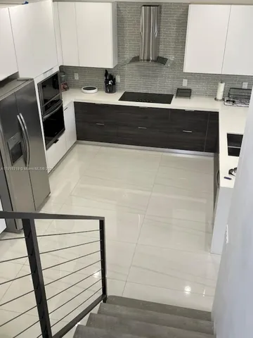 a white toilet sitting next to a small bathroom