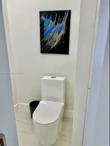 a large bed sitting in a bedroom next to a window