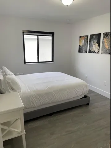 a bathroom with a granite countertop bathtub shower sink and toilet