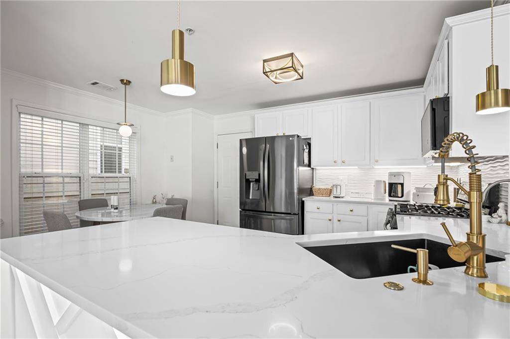 266 Balaban Circle Woodstock, GA 30188 - Photo 11 of 58 a kitchen with a refrigerator a sink and a stove