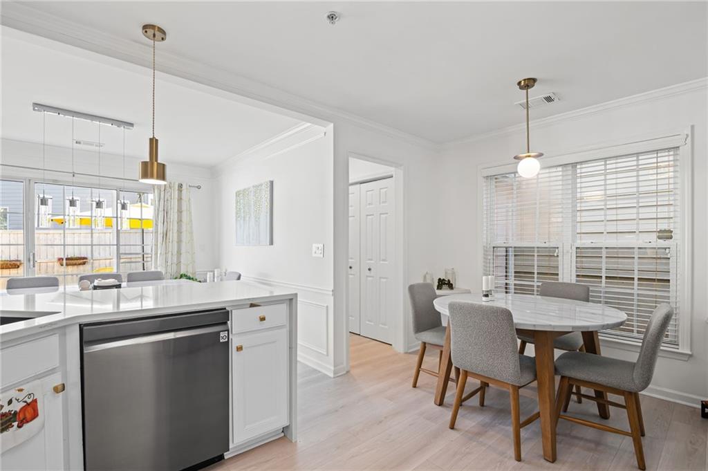 266 Balaban Circle Woodstock, GA 30188 - Photo 13 of 58 a kitchen with a dining table chairs sink and cabinets