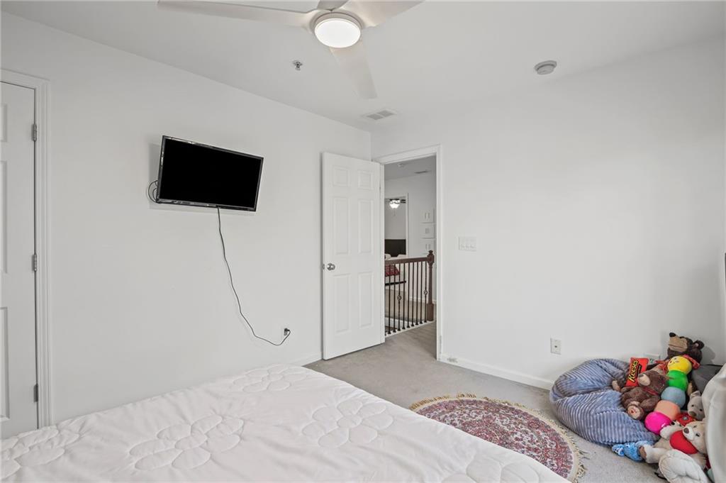 266 Balaban Circle Woodstock, GA 30188 - Photo 20 of 58 a bedroom with a bed and a flat screen tv