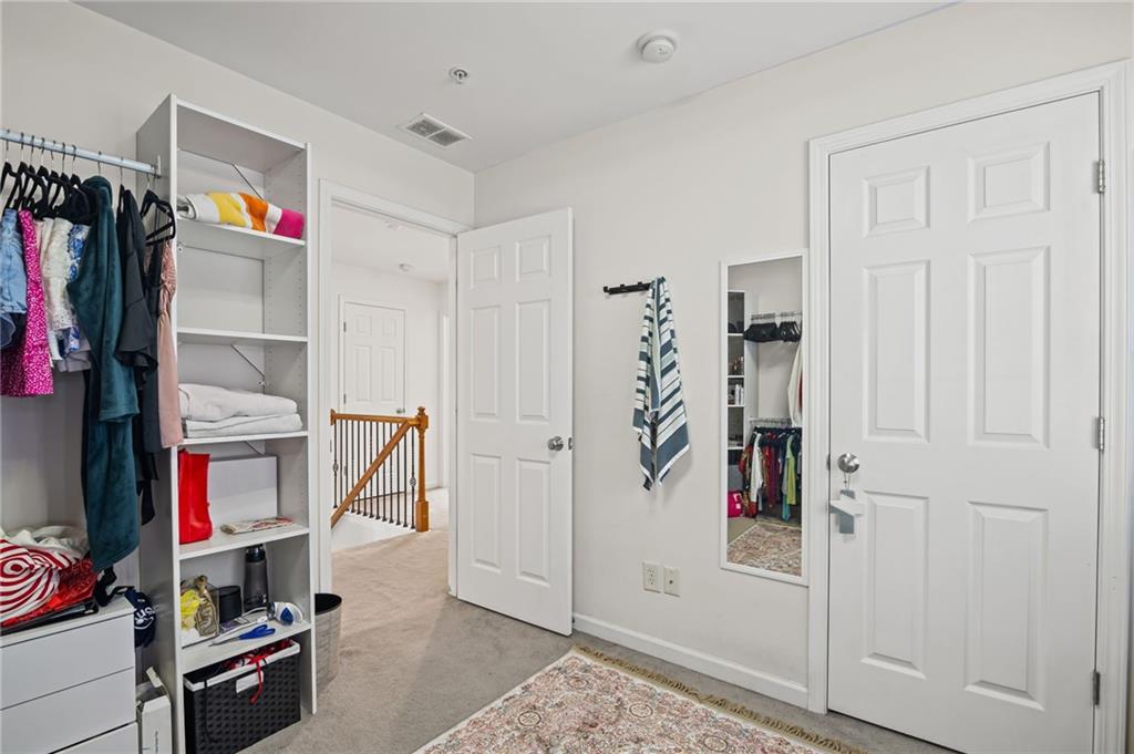 266 Balaban Circle Woodstock, GA 30188 - Photo 23 of 58 a view of walk in closet with clothes and shoes