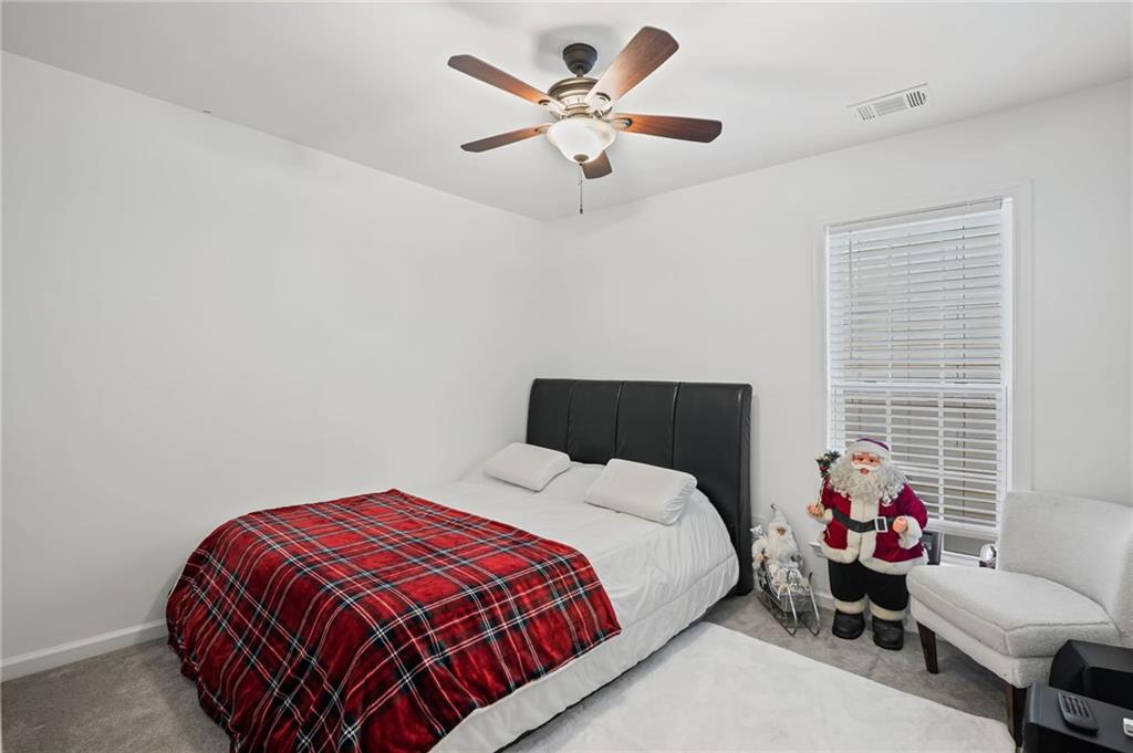 266 Balaban Circle Woodstock, GA 30188 - Photo 24 of 58 a bedroom with a bed and a chandelier