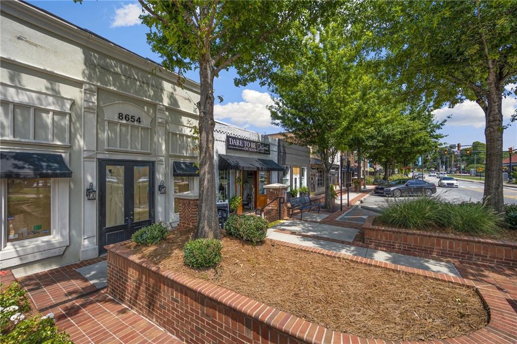 266 Balaban Circle Woodstock, GA 30188 - Photo 36 of 58 a view of a building with brick walls plants and large tree