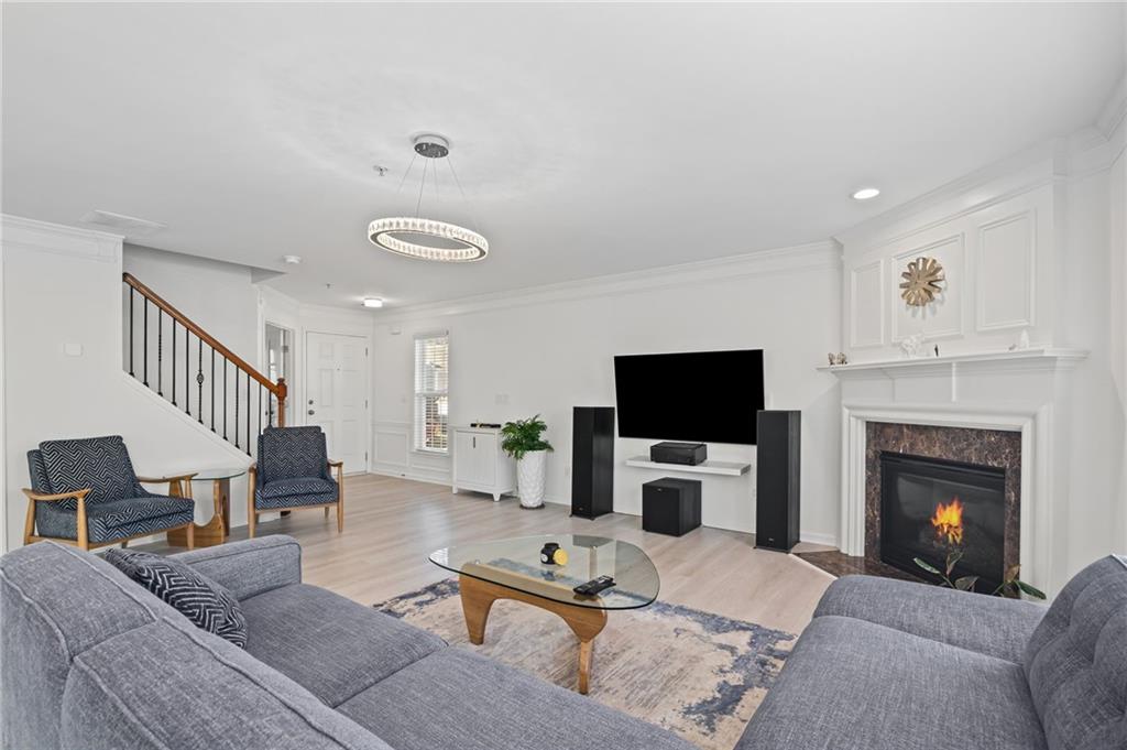266 Balaban Circle Woodstock, GA 30188 - Photo 8 of 58 a living room with furniture a fireplace and a flat screen tv