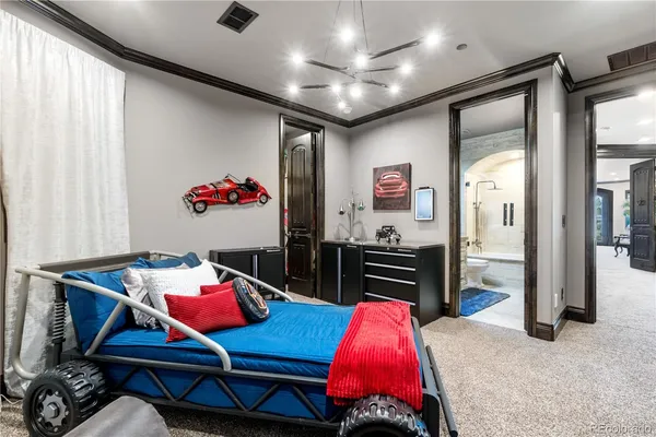 a living room with furniture a flat screen tv and a refrigerator