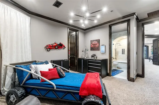 a living room with furniture a flat screen tv and a refrigerator