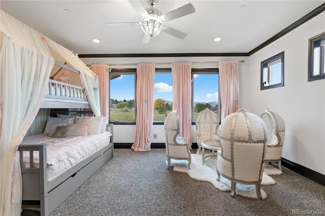 a living room with a bed furniture and a large window