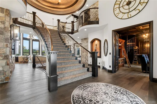 a living room with wooden floor and a chandelier