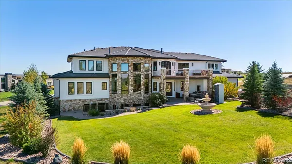 a view of a house with swimming pool and sitting area