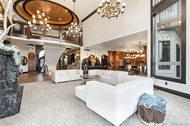 a living room with furniture and a large mirror