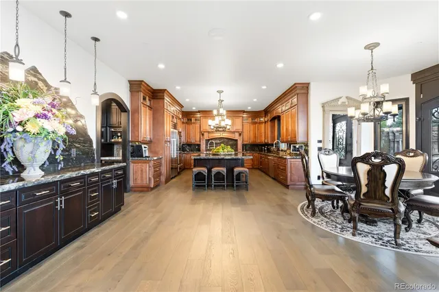 a living room with furniture kitchen view and large windows