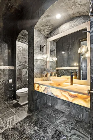 a bathroom with a toilet a sink and bathtub