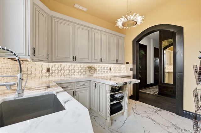 a kitchen with a sink cabinets and window