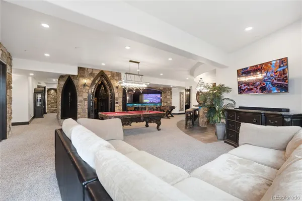 a living room with furniture and kitchen