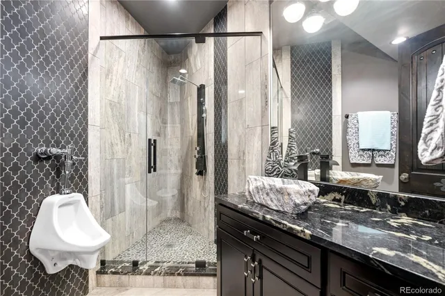 a bathroom with a granite countertop sink and a mirror