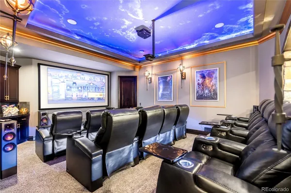 a media room with lots of furniture and a projector