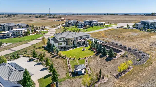 an aerial view of a house with a swimming pool and outdoor seating