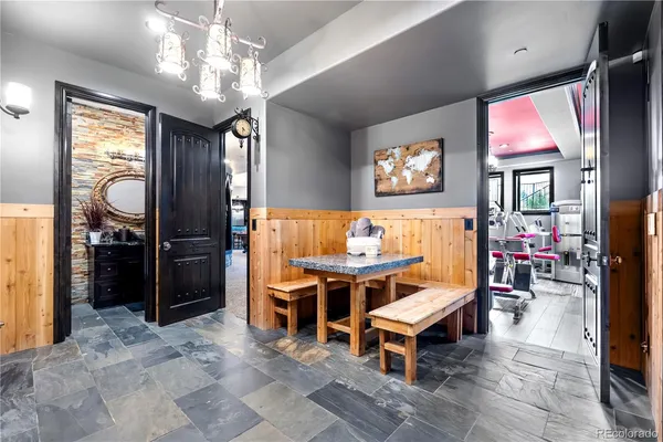 a view of a dining room with furniture and chandelier