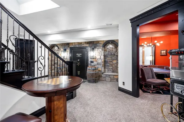a dining room with furniture and a chandelier