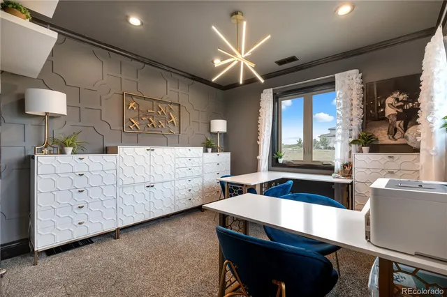 a kitchen with a table chairs refrigerator and sink
