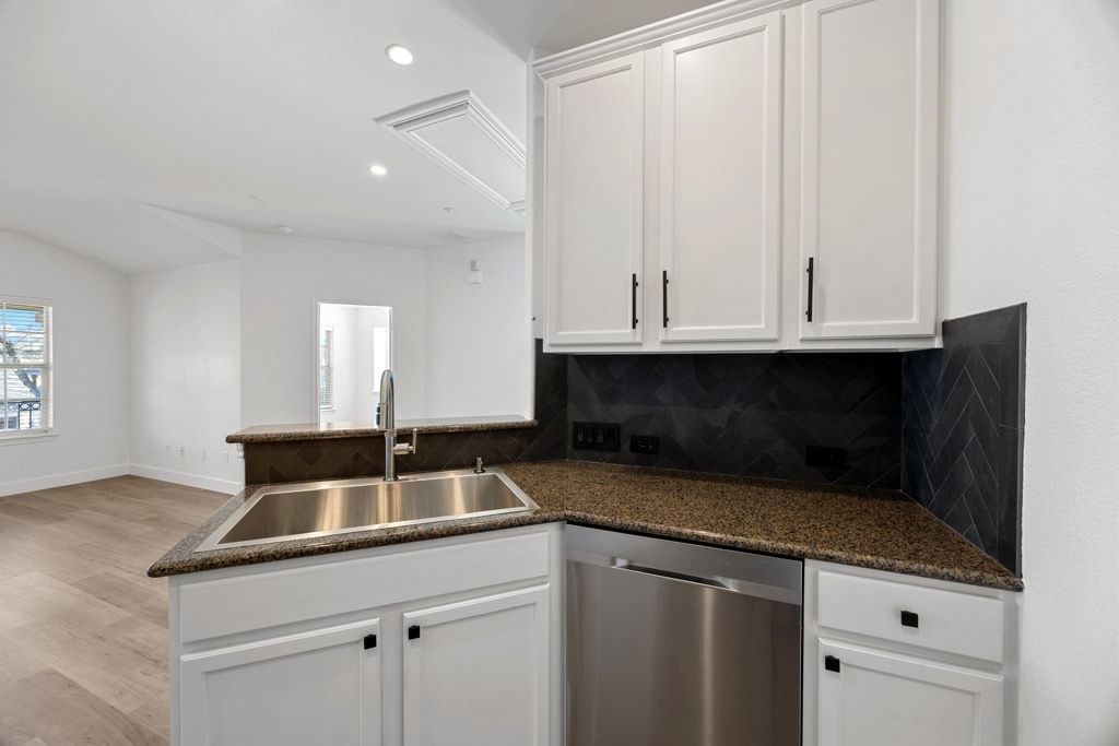 14815 Avery Ranch Boulevard, Unit 1701 Austin, TX 78717 - Photo 11 of 24 a kitchen with granite countertop white cabinets and sink
