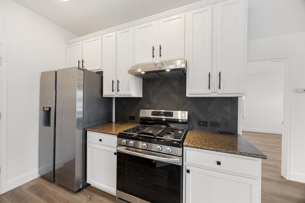 14815 Avery Ranch Boulevard, Unit 1701 Austin, TX 78717 - Photo 12 of 24 a kitchen with stainless steel appliances white cabinets and a stove