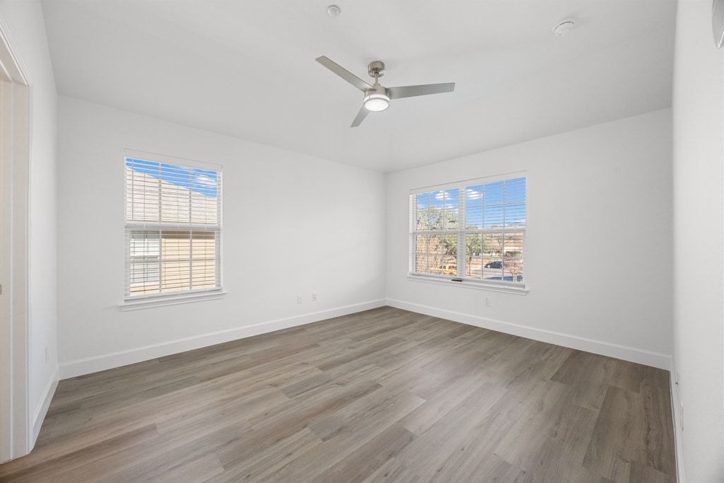 14815 Avery Ranch Boulevard, Unit 1701 Austin, TX 78717 - Photo 15 of 24 a view of an empty room with wooden floor and a window